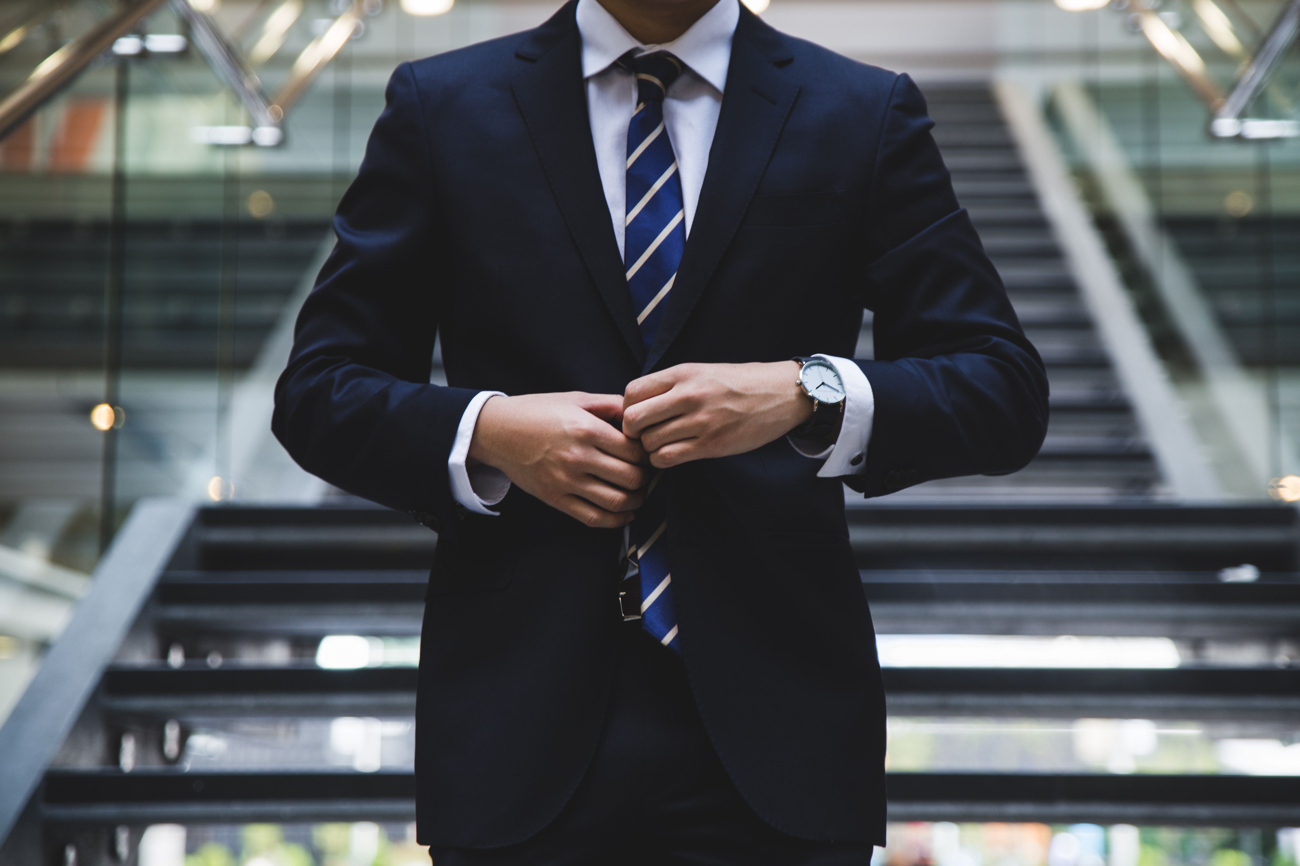 Picture of a man buttoning his suit